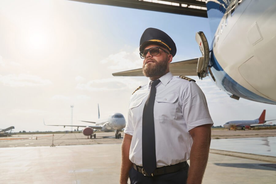 Pilot next to aircraft