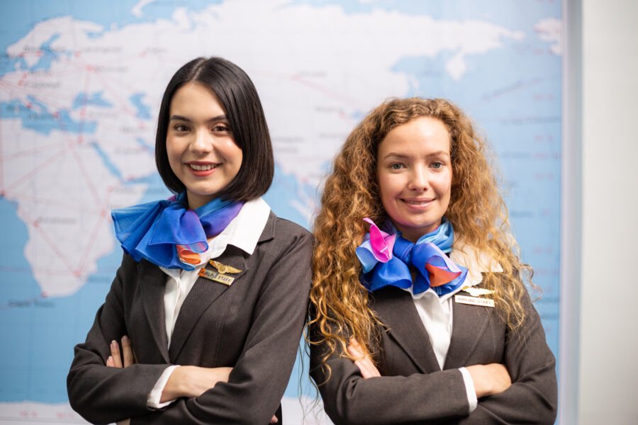 Portrait of female airline officers looking smile at camera at airport office. travel service mind concept Aviation HR