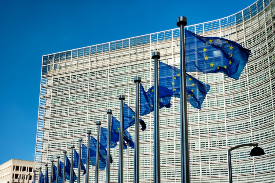 European EU flags in front of the Berlaymont building, headquarters of the European commission in Brussels. Pay Transparency Act
