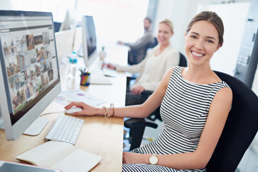 Design is in my blood. Portrait of a young office worker sitting at her workstation in an office. HR Technology.