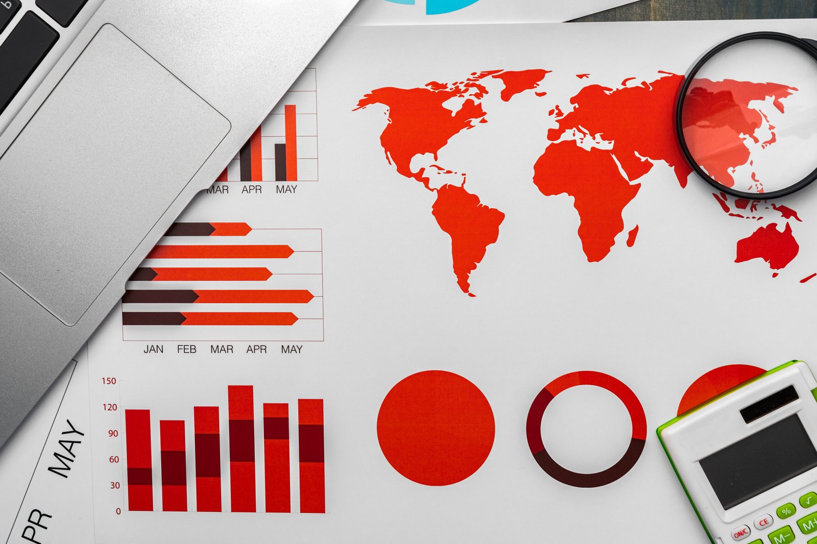 Business data and market analysis displayed with charts, graphs, and a world map. Cross-border workforces create complex compliance challenges.