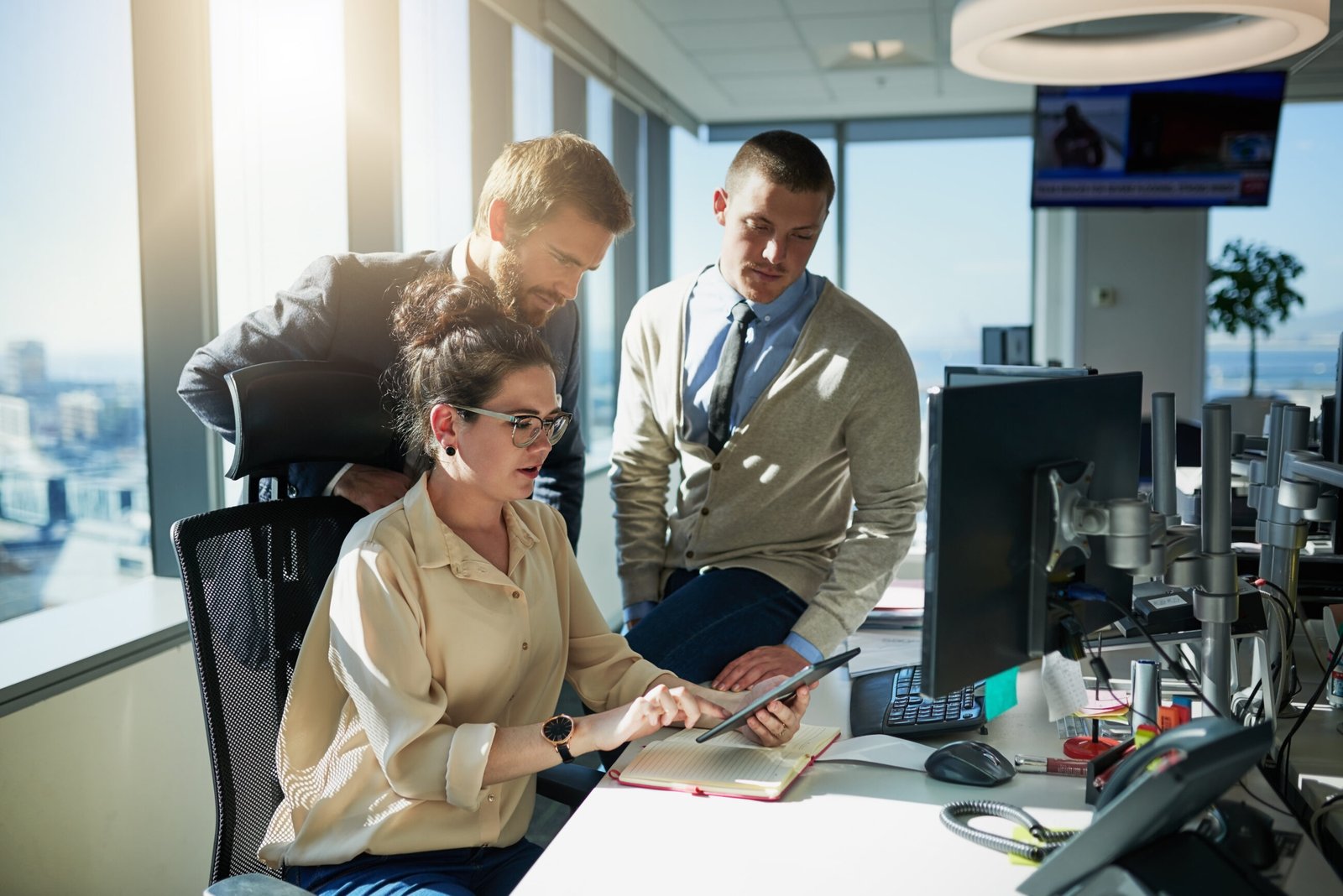 Colleagues working together at computers in a modern office. Scalable HR frameworks for companies in Malta.