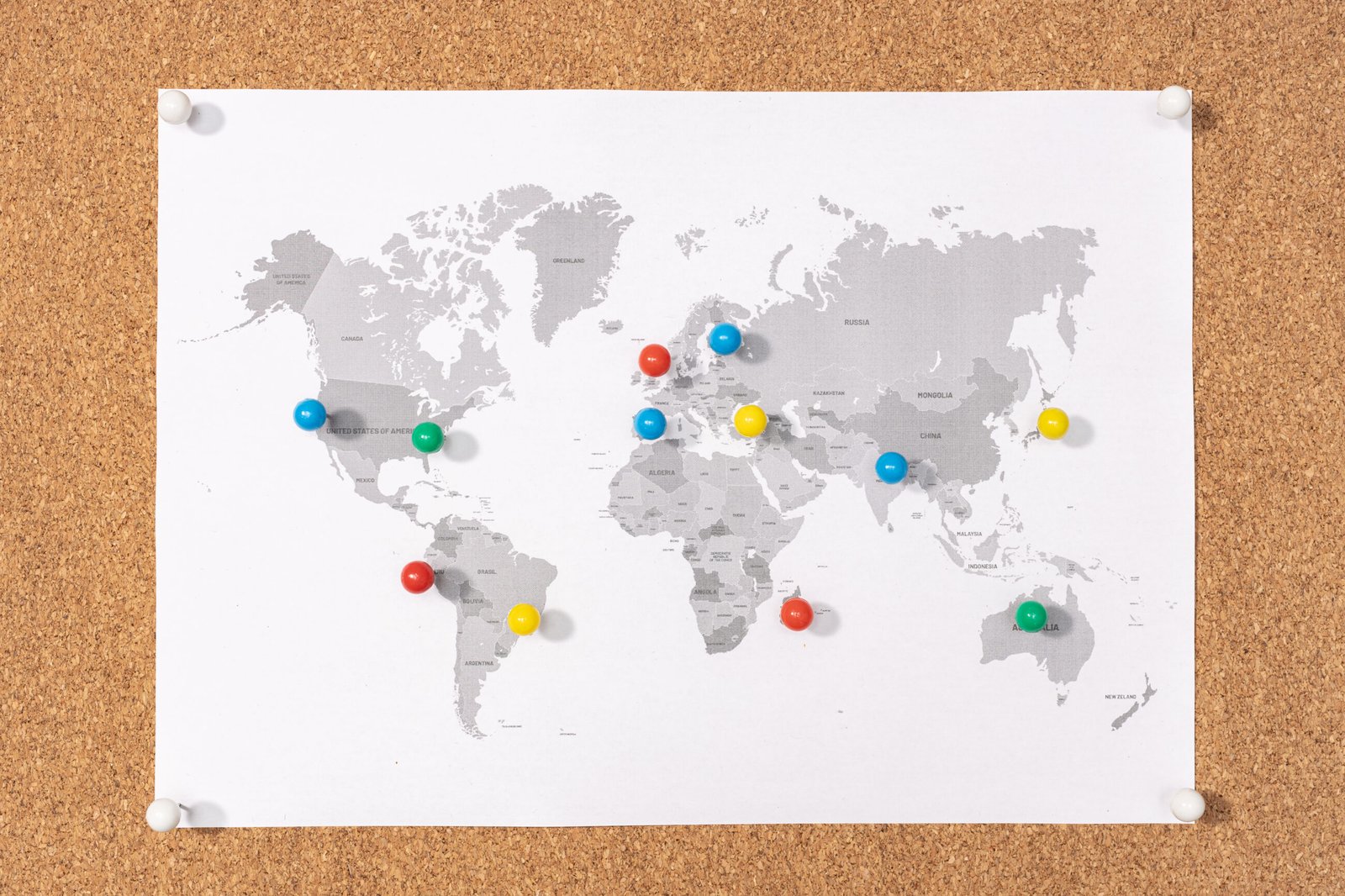 World map with coloured pins marking locations across different countries. Cross-border workforces create complex compliance challenges.