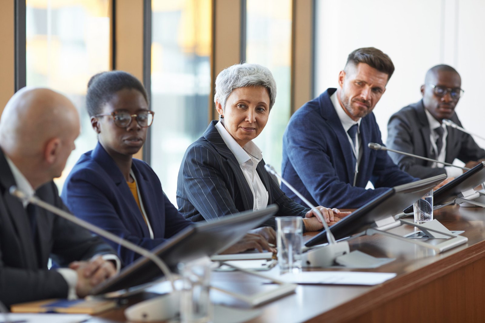 Business professionals attending a meeting around a conference table.