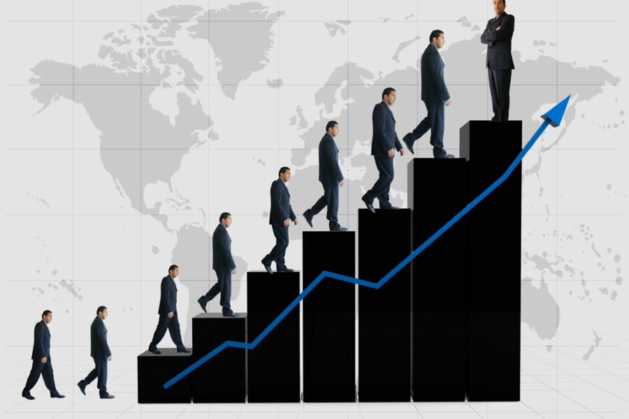 Businessman climbing a series of steps alongside an upward trending graph.