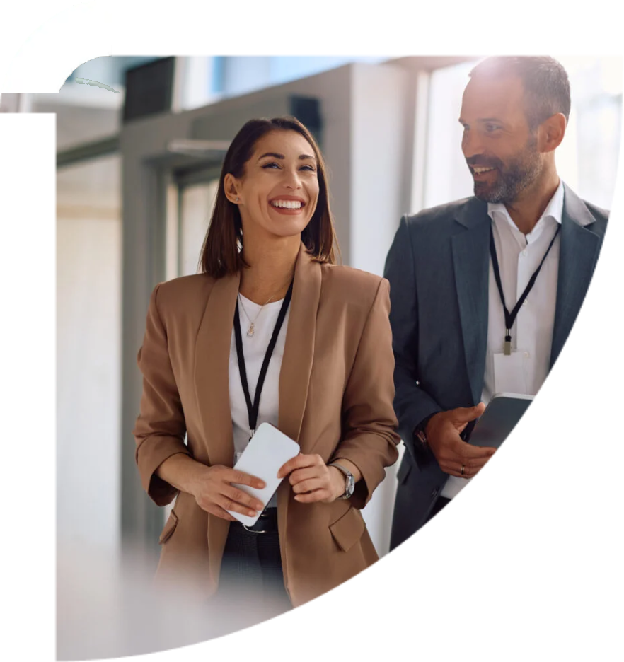 Two colleagues talking as they walk through a bright modern office